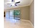 Bright living room featuring tile floors and sliding glass doors at 36750 Us Highway 19 N # 04221, Palm Harbor, FL 34684