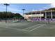 Tennis courts with a clubhouse in the background at 36750 Us Highway 19 N # 04221, Palm Harbor, FL 34684