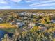 Aerial view of a neighborhood with houses, lush trees, and a lake at 3870 155Th E Ave, Parrish, FL 34219