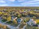 Aerial view of a house and neighborhood near a lake at sunset at 3870 155Th E Ave, Parrish, FL 34219