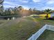 Backyard with white fence and a view of a peaceful lake at 3870 155Th E Ave, Parrish, FL 34219