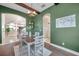 Bright dining room with green walls and wooden table at 3870 155Th E Ave, Parrish, FL 34219