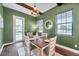 Charming dining room with green walls and rustic wooden table at 3870 155Th E Ave, Parrish, FL 34219