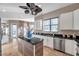 Bright kitchen with an island, white cabinets, and a view to the Gathering room at 3870 155Th E Ave, Parrish, FL 34219