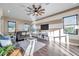 Living room with hardwood floors, neutral color palette, and large windows overlooking backyard at 3870 155Th E Ave, Parrish, FL 34219