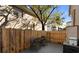 Small backyard patio with wooden deck and seating for two at 408 S Arrawana Ave # C4, Tampa, FL 33609