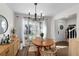 Bright dining room with wooden table and modern chandelier at 408 S Arrawana Ave # C4, Tampa, FL 33609