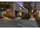 Evening view of townhouse building with walkway and landscaping at 408 S Arrawana Ave # C4, Tampa, FL 33609