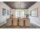 Bright dining room with a wood table, beige chairs, and a modern chandelier at 4224 W Kensington Ave, Tampa, FL 33629