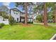 Two-story house with light gray siding, landscaping, and a paved driveway at 4224 W Kensington Ave, Tampa, FL 33629