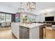 Modern white kitchen with island, stainless steel appliances, and hardwood floors at 4224 W Kensington Ave, Tampa, FL 33629