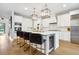 Modern white kitchen with island, stainless steel appliances, and hardwood floors at 4224 W Kensington Ave, Tampa, FL 33629