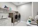 Bright laundry room with washer, dryer, and storage at 4224 W Kensington Ave, Tampa, FL 33629