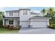 Two-story house with gray siding, stone accents, and a three-car garage at 4330 Pullet Ct, Bradenton, FL 34211