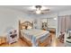 Cozy bedroom with ceiling fan and striped bedding at 4333 Trails Dr # 10-1, Sarasota, FL 34232