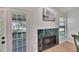 Fireplace with green tile surround and built-in shelving at 4333 Trails Dr # 10-1, Sarasota, FL 34232