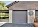 Gray double-car garage door and stucco wall at 4333 Trails Dr # 10-1, Sarasota, FL 34232