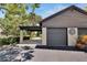 Two-car garage with dark gray doors and a sun design at 4333 Trails Dr # 10-1, Sarasota, FL 34232