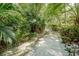 Paved pathway winds through a lush tropical landscape at 4333 Trails Dr # 10-1, Sarasota, FL 34232