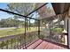 Screened porch with wooden deck and backyard view at 4333 Trails Dr # 10-1, Sarasota, FL 34232