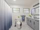 Modern bathroom with gray cabinets, white countertop, and marble flooring at 4702 W Bay Ave, Tampa, FL 33616