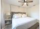 Main bedroom with plush bed, nightstands, and ceiling fan at 4702 W Bay Ave, Tampa, FL 33616