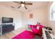 Cozy bedroom with a pink rug and seating area at 4702 W Bay Ave, Tampa, FL 33616