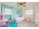 bedroom with twin bed, desk, and aqua walls at 4702 W Bay Ave, Tampa, FL 33616