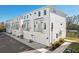 Row of modern townhomes with attached garages and landscaping at 4722 Legacy Park Dr, Tampa, FL 33611