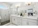 Elegant bathroom with double vanity, large shower, and modern fixtures at 4722 Legacy Park Dr, Tampa, FL 33611