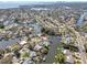 Expansive aerial view showcasing waterfront homes along winding canals with city views in the distance at 4801 Venetian Ne Pl, St Petersburg, FL 33703