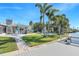 A gorgeous view from the dock of the backyard pool with a beautiful green yard and patio at 4801 Venetian Ne Pl, St Petersburg, FL 33703