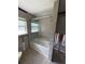 Modern bathroom featuring decorative tile walls and glass door over bathtub at 4801 Venetian Ne Pl, St Petersburg, FL 33703