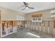 Bedroom featuring a ceiling fan, window with blinds, and unfinished walls at 4801 Venetian Ne Pl, St Petersburg, FL 33703