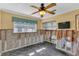 Bedroom featuring a ceiling fan, window with curtains, and unfinished walls at 4801 Venetian Ne Pl, St Petersburg, FL 33703