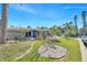 Exterior view of the home showing the back porch and stone landscaping in the backyard at 4801 Venetian Ne Pl, St Petersburg, FL 33703