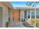 Close-up of a charming home entrance with a stylish front door, brick details, and manicured landscaping, offering a warm welcome at 4801 Venetian Ne Pl, St Petersburg, FL 33703