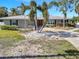 Cozy home featuring a well-manicured lawn, brick driveway, mature landscaping, and a charming facade, creating a welcoming atmosphere at 4801 Venetian Ne Pl, St Petersburg, FL 33703