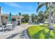 Outdoor dining area on the patio with table, chairs, grill, and views of the landscaped yard and pool at 4801 Venetian Ne Pl, St Petersburg, FL 33703