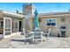 Cozy patio area features outdoor dining and a decorative mosaic chimney, perfect for entertaining at 4801 Venetian Ne Pl, St Petersburg, FL 33703