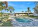 Backyard pool with a patio and a view of the property's exterior with beautiful green backyard grass at 4801 Venetian Ne Pl, St Petersburg, FL 33703