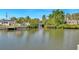 A peaceful canal view of the waterfront featuring a bridge, beautiful homes, and lush greenery at 4801 Venetian Ne Pl, St Petersburg, FL 33703