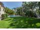 Spacious backyard with lush landscaping and pool at 5020 W Dickens Ave, Tampa, FL 33629