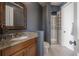 Bathroom with granite vanity, tiled shower, and modern fixtures at 5020 W Dickens Ave, Tampa, FL 33629