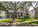 Two-story house with a three-car garage and manicured lawn at 5020 W Dickens Ave, Tampa, FL 33629