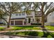 Two-story house with a three-car garage and manicured lawn at 5020 W Dickens Ave, Tampa, FL 33629