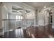 Upstairs hallway with hardwood floors and elegant railing at 5020 W Dickens Ave, Tampa, FL 33629