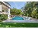 Inviting pool area with lounge chairs and lush landscaping at 5020 W Dickens Ave, Tampa, FL 33629