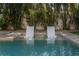 Two chaises are partially submerged in the pool at 5020 W Dickens Ave, Tampa, FL 33629