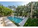 Inviting swimming pool with surrounding patio and lush landscaping at 5020 W Dickens Ave, Tampa, FL 33629